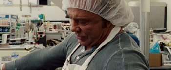Movie still from “The Wrestler” (2008), directed by Darren Aronofsky – An older man wearing an apron and head covering; Close Up shot, Low angle