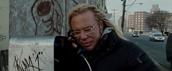 Movie still from “The Wrestler” (2008), directed by Darren Aronofsky – A man talking on a phone while standing next to a building; Close Up shot, Low angle