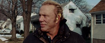 Movie still from “The Wrestler” (2008), directed by Darren Aronofsky – A person wearing a ear piece; Close Up shot, Low angle