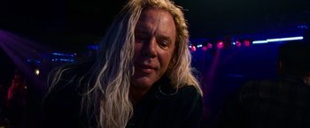 Movie still from “The Wrestler” (2008), directed by Darren Aronofsky – A man with long blonde hair is looking at the camera; Close Up shot, Low angle