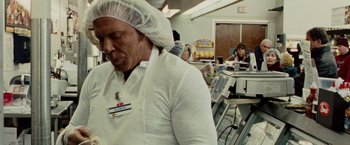Movie still from “The Wrestler” (2008), directed by Darren Aronofsky – A man wearing a white shirt and a white hat; Medium shot, Over the shoulder angle