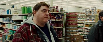 Movie still from “The Wrestler” (2008), directed by Darren Aronofsky – A man standing in front of shelves in a grocery store; Medium shot, Over the shoulder angle