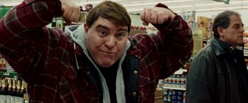 Movie still from “The Wrestler” (2008), directed by Darren Aronofsky – A man in a plaid jacket is posing for a picture; Close Up shot, Low angle