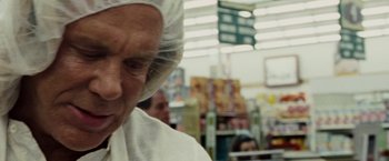 Movie still from “The Wrestler” (2008), directed by Darren Aronofsky – An older woman wearing a head covering in a store; Close Up shot, Over the shoulder angle