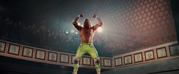 Movie still from “The Wrestler” (2008), directed by Darren Aronofsky – A man in green pants is standing in a ring; Wide shot, Low angle