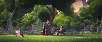 Movie still from “DC League of Super-Pets” (2022), directed by Jared Stern – A man sitting on a park bench next to a tree; Extreme Wide shot, Over the shoulder angle