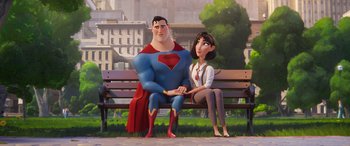 Movie still from “DC League of Super-Pets” (2022), directed by Jared Stern – A man and a woman sitting on a wooden bench; Medium shot, Over the shoulder angle