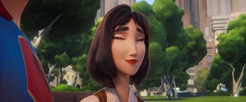 Movie still from “DC League of Super-Pets” (2022), directed by Jared Stern – A woman with brown hair and red lipstick is smiling; Close Up shot, Low angle