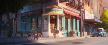 Movie still from “DC League of Super-Pets” (2022), directed by Jared Stern – A man walking down the sidewalk in front of tall huggers; Wide shot, Over the shoulder angle