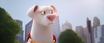 Movie still from “DC League of Super-Pets” (2022), directed by Jared Stern – A white dog with a red collar is standing in front of a city; Close Up shot, Over the shoulder angle