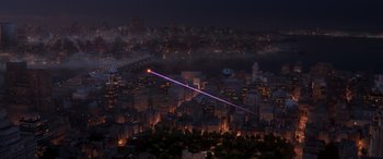 Movie still from “DC League of Super-Pets” (2022), directed by Jared Stern – An aerial view of a city at night with a purple laser beam; Extreme Wide shot, High angle