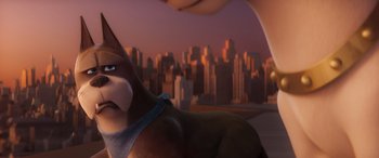 Movie still from “DC League of Super-Pets” (2022), directed by Jared Stern – A person petting a dog in front of a city skyline; Close Up shot, High angle