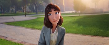 Movie still from “DC League of Super-Pets” (2022), directed by Jared Stern – A woman in a gray jacket is smiling; Close Up shot, Over the shoulder angle