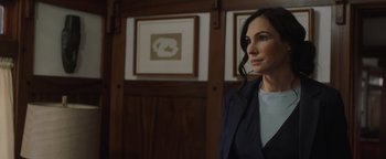 Movie still from “Dangerous” (2021), directed by David Hackl – A woman standing in front of a wooden wall; Close Up shot, Over the shoulder angle