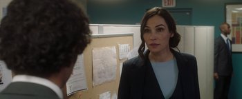Movie still from “Dangerous” (2021), directed by David Hackl – A woman standing in front of a man in an office setting; Close Up shot, Over the shoulder angle