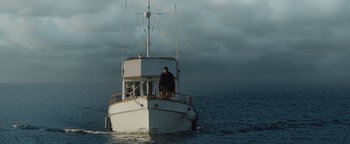 Movie still from “Dangerous” (2021), directed by David Hackl – A man on a boat in the water; Extreme Wide shot, Low angle