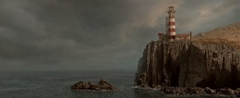 Movie still from “Dangerous” (2021), directed by David Hackl – A cliff with a lighthouse on top of it near the ocean; Extreme Wide shot, High angle