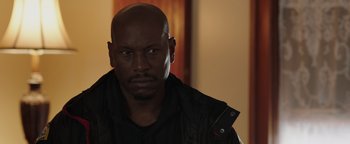 Movie still from “Dangerous” (2021), directed by David Hackl – A man with a black shirt and a black jacket; Close Up shot, Low angle