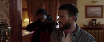 Movie still from “Dangerous” (2021), directed by David Hackl – A man with a beard is holding a gun and another man with a beard is holding a gun; Close Up shot, Over the shoulder angle
