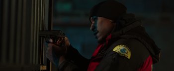 Movie still from “Dangerous” (2021), directed by David Hackl – A man holding a gun while standing in the dark; Close Up shot, Low angle