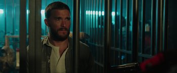 Movie still from “Dangerous” (2021), directed by David Hackl – A person behind bars in a room; Close Up shot, Low angle