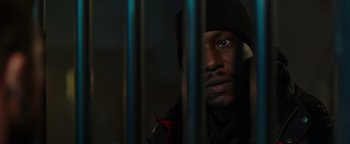 Movie still from “Dangerous” (2021), directed by David Hackl – A person behind a metal fence; Close Up shot, Low angle