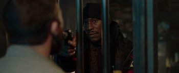 Movie still from “Dangerous” (2021), directed by David Hackl – A man holding a gun in front of another man; Close Up shot, Over the shoulder angle