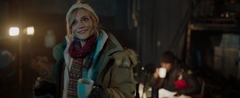 Movie still from “Dangerous” (2021), directed by David Hackl – A woman holding a cup of coffee in a room; Medium shot, Over the shoulder angle