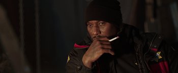 Movie still from “Dangerous” (2021), directed by David Hackl – A man in a black jacket holding a cigarette in his mouth; Close Up shot, High angle