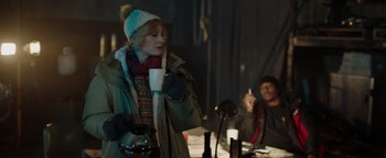 Movie still from “Dangerous” (2021), directed by David Hackl – A woman holding a coffee mug while standing next to a man; Medium shot, Over the shoulder angle