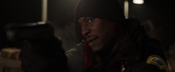 Movie still from “Dangerous” (2021), directed by David Hackl – A person wearing a jacket and a hat; Close Up shot, Low angle
