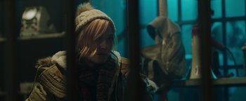 Movie still from “Dangerous” (2021), directed by David Hackl – A young girl wearing a hat and a sweater; Close Up shot, Over the shoulder angle