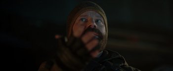 Movie still from “Dangerous” (2021), directed by David Hackl – A man with a beard wearing a hat and gloves; Close Up shot, Low angle