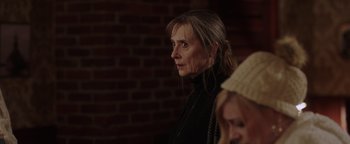 Movie still from “Dangerous” (2021), directed by David Hackl – A woman standing in front of a brick wall; Close Up shot, Over the shoulder angle