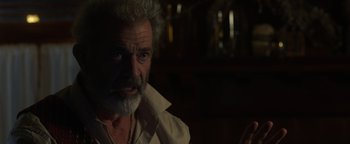 Movie still from “Dangerous” (2021), directed by David Hackl – An older man with a beard and a white mustache; Close Up shot, Over the shoulder angle