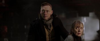 Movie still from “Dangerous” (2021), directed by David Hackl – A person wearing a coat; Close Up shot, Over the shoulder angle