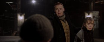 Movie still from “Dangerous” (2021), directed by David Hackl – A man standing in front of another man in the dark; Medium shot, Over the shoulder angle