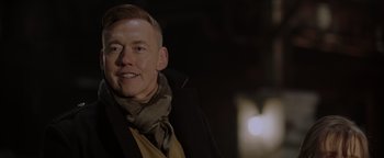 Movie still from “Dangerous” (2021), directed by David Hackl – A person wearing a jacket and a scarf; Close Up shot, Low angle