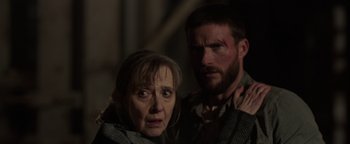 Movie still from “Dangerous” (2021), directed by David Hackl – A man and a woman are standing next to each other; Close Up shot, Over the shoulder angle