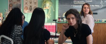 Movie still from “Darby and the Dead” (2022), directed by Silas Howard – Two women sitting at a table in front of each other; Medium shot, Over the shoulder angle