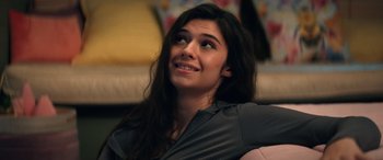 Movie still from “Darby and the Dead” (2022), directed by Silas Howard – A woman sitting on a couch looking up at the sky; Close Up shot, Over the shoulder angle