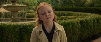 Movie still from “Dark Phoenix” (2019), directed by Simon Kinberg – A little girl with red hair and eyes closed; Close Up shot, High angle