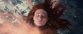 Movie still from “Dark Phoenix” (2019), directed by Simon Kinberg – A woman laying on top of the ground with her eyes closed; Close Up shot, Overhead angle