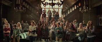 Movie still from “Dark Phoenix” (2019), directed by Simon Kinberg – A group of people standing in front of a large chandelier; Wide shot, High angle
