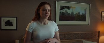 Movie still from “Dark Phoenix” (2019), directed by Simon Kinberg – A woman in a white t - shirt standing in front of a painting; Medium shot, Over the shoulder angle