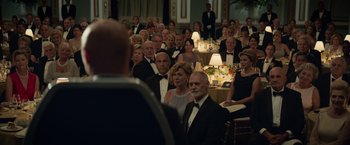 Movie still from “Dark Phoenix” (2019), directed by Simon Kinberg – A group of people sitting at a table in formal wear; Wide shot, Over the shoulder angle