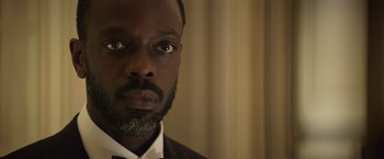 Movie still from “Dark Phoenix” (2019), directed by Simon Kinberg – A person wearing a suit and tie; Close Up shot, Low angle