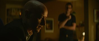Movie still from “Dark Phoenix” (2019), directed by Simon Kinberg – A man with a bald head is looking at the camera; Close Up shot, Over the shoulder angle
