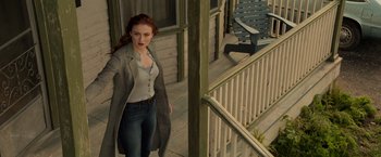 Movie still from “Dark Phoenix” (2019), directed by Simon Kinberg – A woman standing on the porch of a house; Wide shot, Low angle