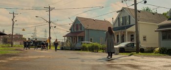 Movie still from “Dark Phoenix” (2019), directed by Simon Kinberg – Two people walking down the street in front of a house; Wide shot, Low angle